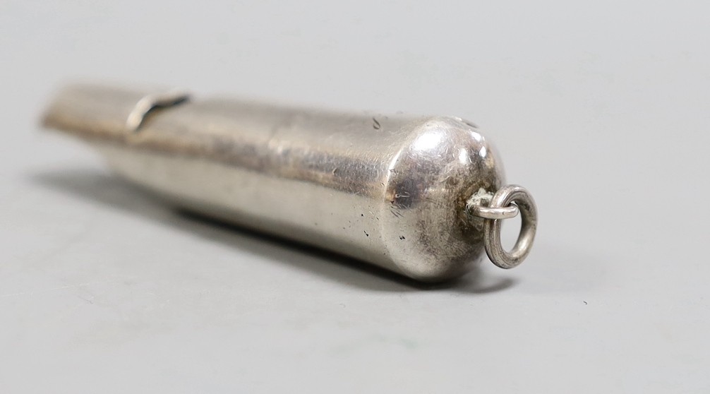 An early 20th century Chinese Export white metal whistle by Wang Hing, Hong Kong, 71mm.